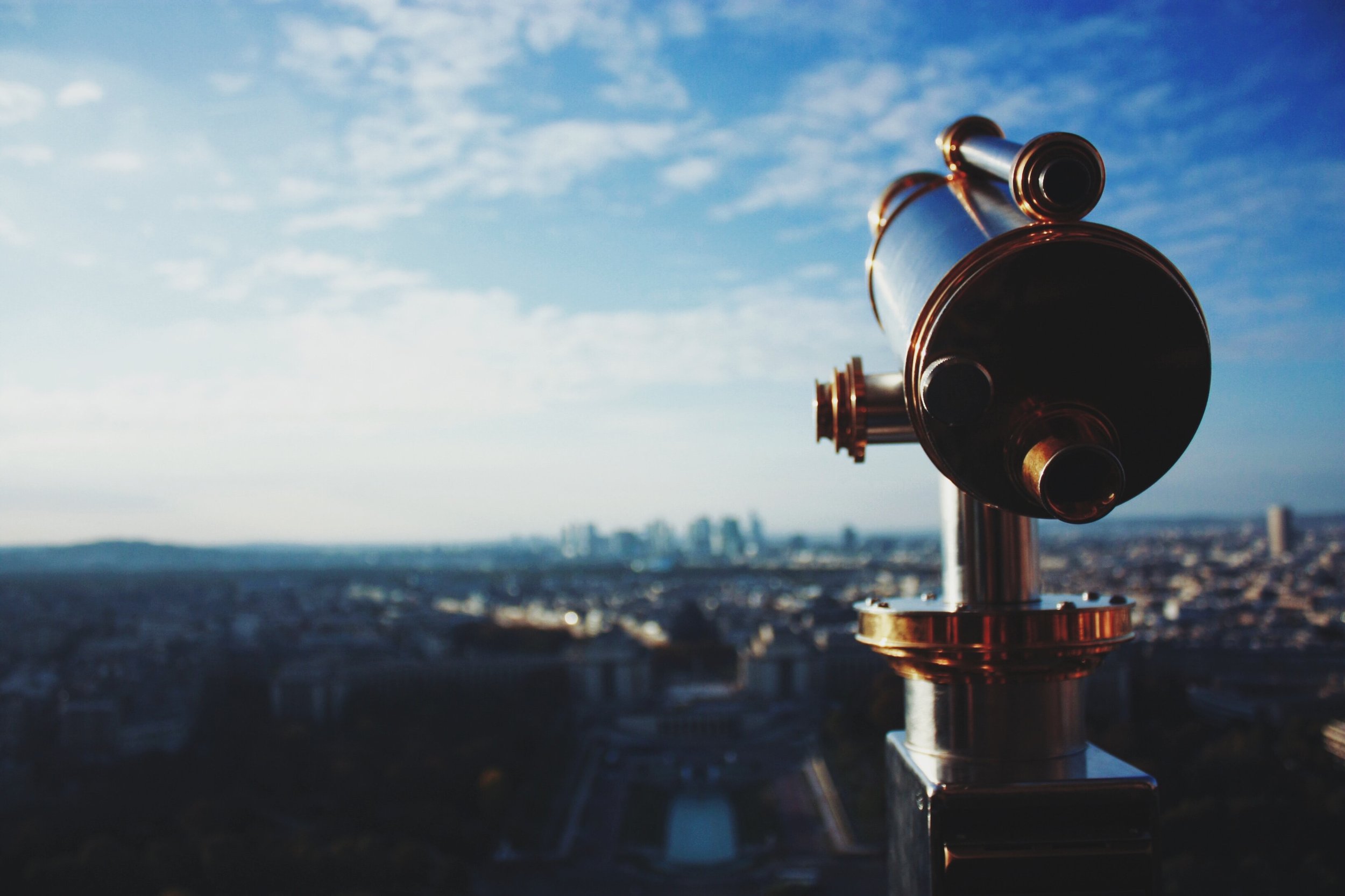 A public telescope overlooking a city